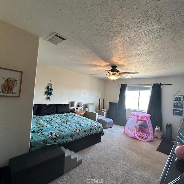 bedroom with carpet, a textured ceiling, and ceiling fan