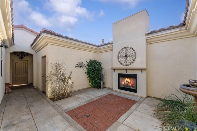 view of patio / terrace featuring exterior fireplace