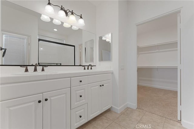 bathroom featuring vanity, tile patterned floors, and walk in shower