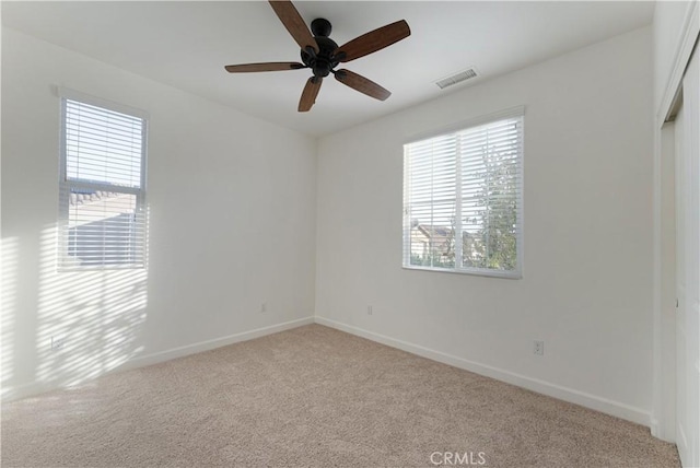 carpeted empty room featuring ceiling fan