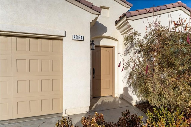 doorway to property with a garage