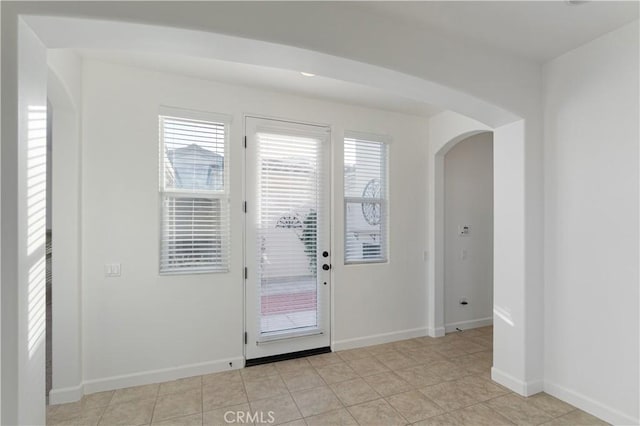 entryway with light tile patterned floors and a healthy amount of sunlight