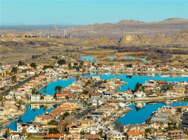 drone / aerial view featuring a water and mountain view