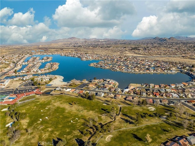 birds eye view of property with a water and mountain view