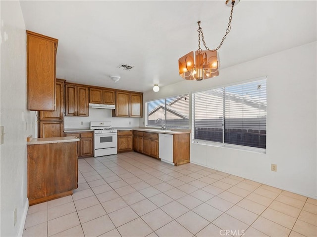 kitchen featuring hanging light fixtures, a chandelier, white appliances, and light tile patterned floors