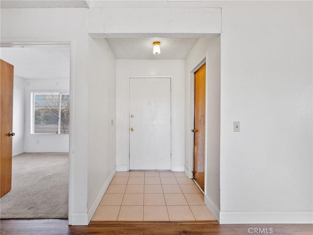 interior space featuring a textured ceiling and light tile patterned floors