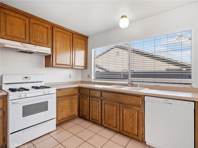 kitchen featuring sink, white appliances, and light tile patterned floors