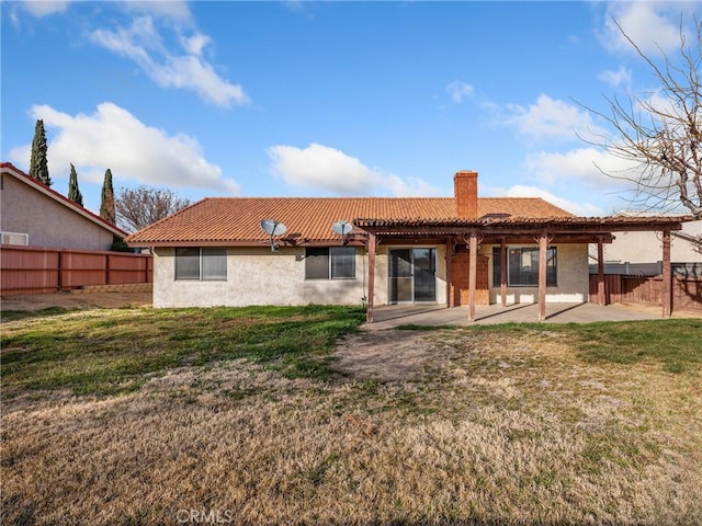 rear view of house featuring a yard and a patio area