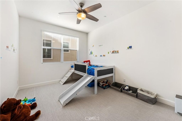 bedroom featuring ceiling fan and carpet