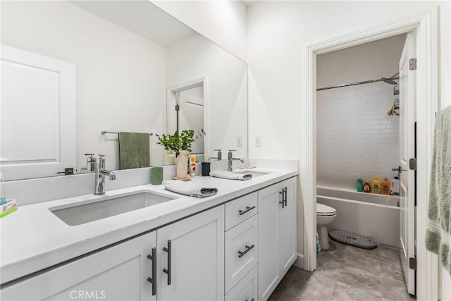 full bathroom with tiled shower / bath, vanity, and toilet