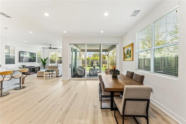 dining room featuring plenty of natural light, ceiling fan, and light hardwood / wood-style flooring