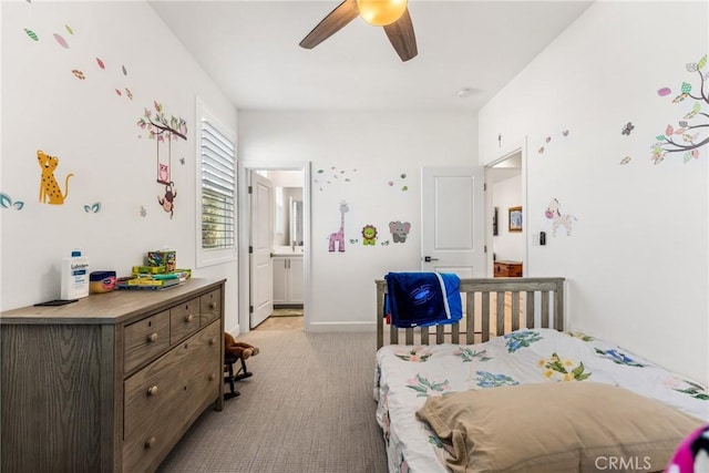 bedroom featuring light carpet, connected bathroom, and ceiling fan