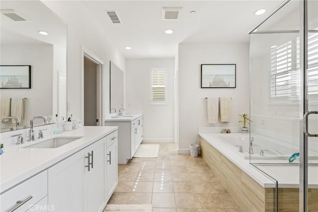 bathroom featuring tile patterned floors, plus walk in shower, and vanity