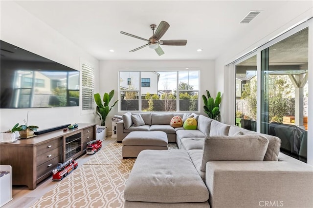 living room with ceiling fan and light hardwood / wood-style floors