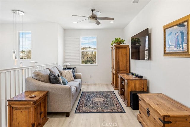 living room with ceiling fan and light wood-type flooring