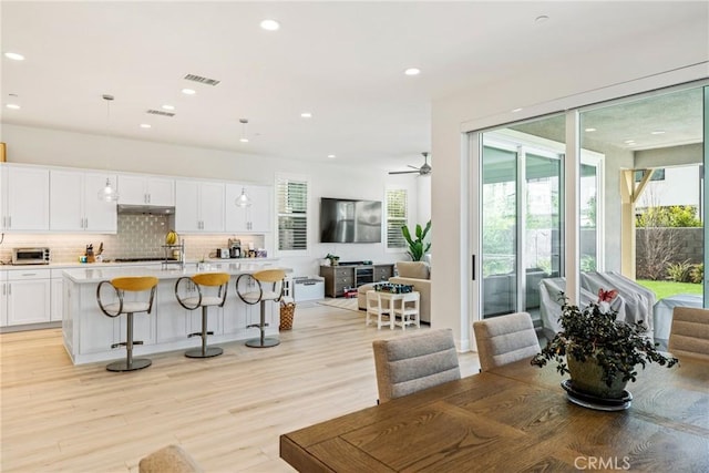 dining room featuring ceiling fan and light wood-type flooring