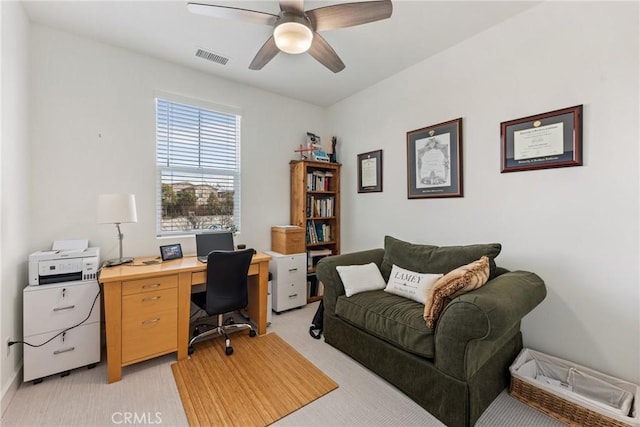 office area featuring light carpet and ceiling fan