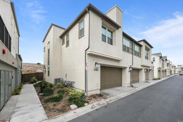 exterior space featuring a garage and central AC unit