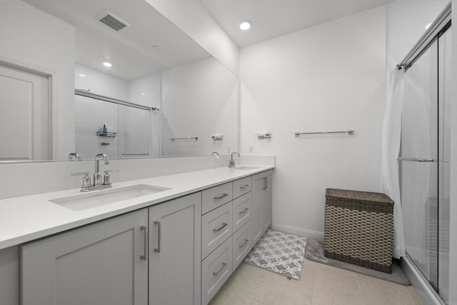 bathroom featuring vanity, tile patterned flooring, and walk in shower