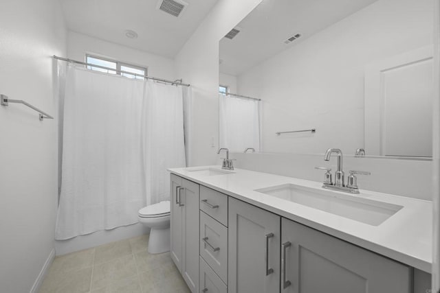 full bathroom with tile patterned floors, toilet, vanity, and shower / bathtub combination with curtain