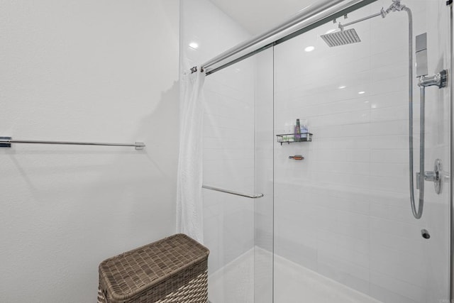 bathroom featuring a shower with shower door