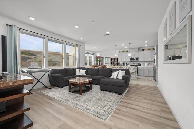 2082 Trevi Cir, Chula Vista, CA 91913 - living area featuring light wood-type flooring, recessed lighting, and baseboards