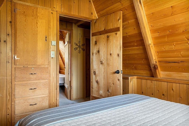 unfurnished bedroom featuring wood walls