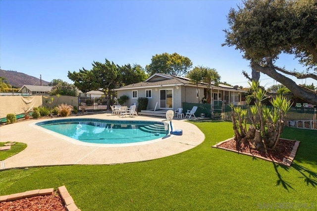 view of swimming pool with a patio area and a lawn