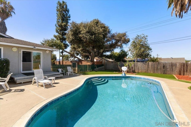 view of swimming pool with a patio area