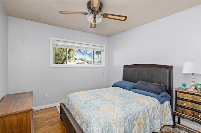 bedroom with hardwood / wood-style flooring and ceiling fan