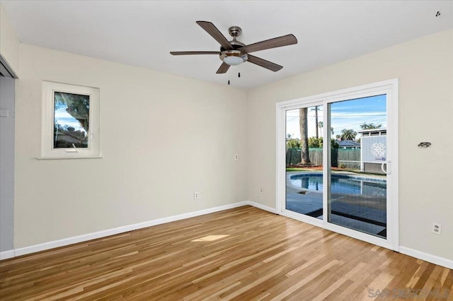 empty room with hardwood / wood-style floors and ceiling fan