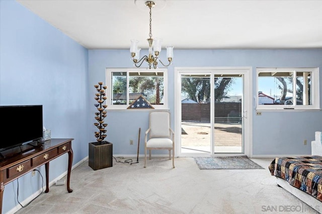 living area with a notable chandelier and light colored carpet