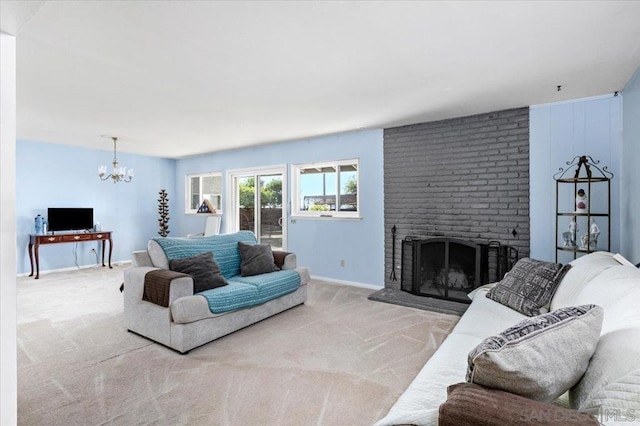 living room with carpet, an inviting chandelier, and a brick fireplace