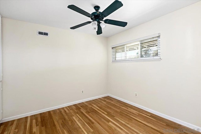 unfurnished room with hardwood / wood-style flooring and ceiling fan