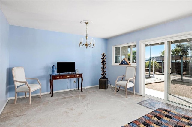 living area featuring an inviting chandelier and light carpet