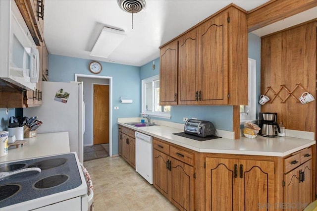 kitchen with sink and white appliances