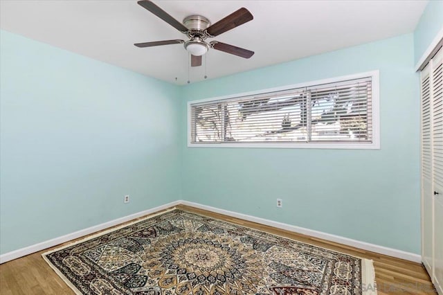 unfurnished room featuring ceiling fan and hardwood / wood-style floors