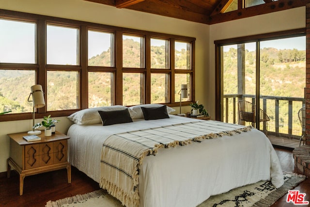 bedroom with vaulted ceiling and wood-type flooring