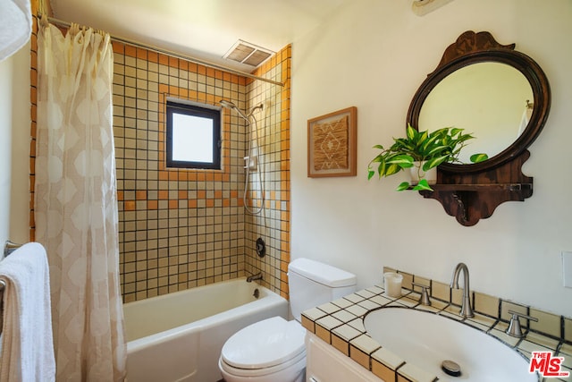 full bathroom with vanity, shower / bath combination with curtain, and toilet