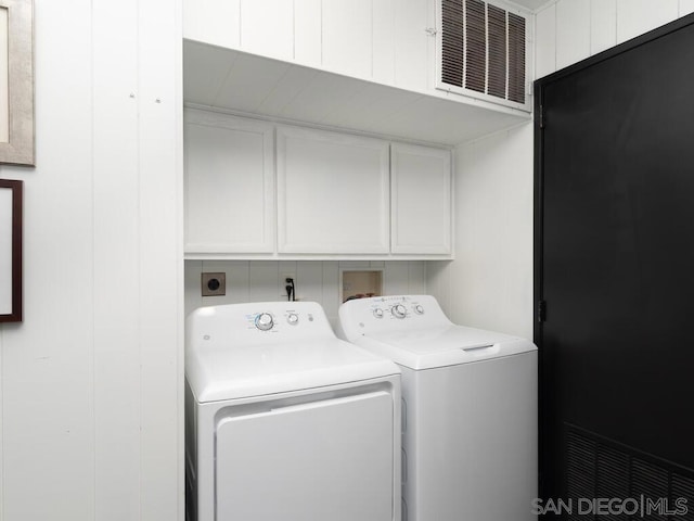 laundry area with cabinets and washer and clothes dryer