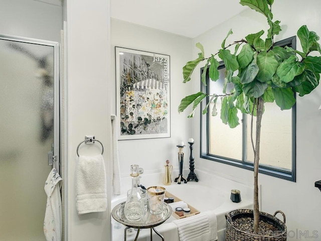 bathroom featuring separate shower and tub