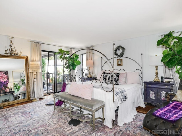 bedroom featuring hardwood / wood-style flooring and access to outside