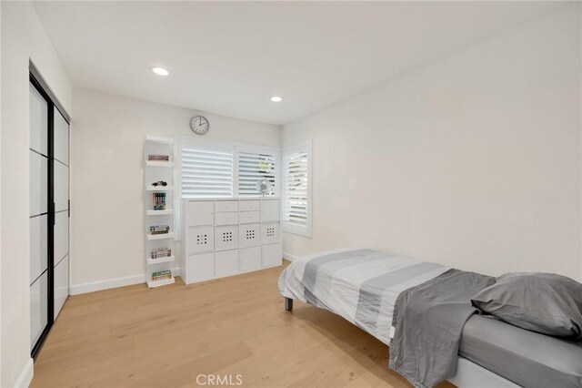 bedroom with light hardwood / wood-style flooring