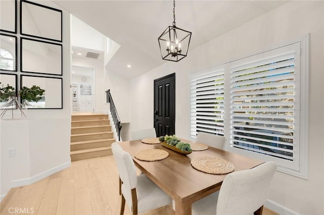 dining room featuring a notable chandelier and light hardwood / wood-style flooring