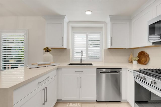 kitchen with white cabinetry, sink, and appliances with stainless steel finishes