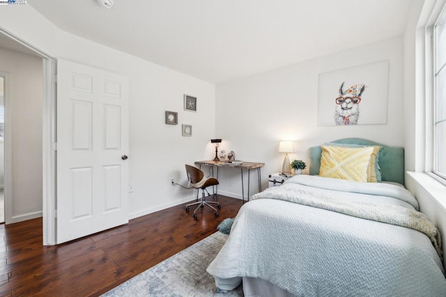 bedroom with dark wood-type flooring