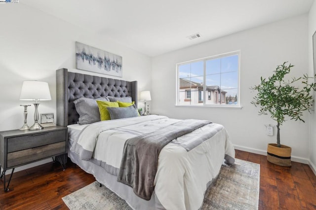 bedroom with dark hardwood / wood-style floors