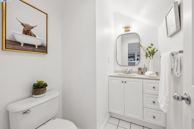 bathroom featuring vanity, tile patterned floors, and toilet