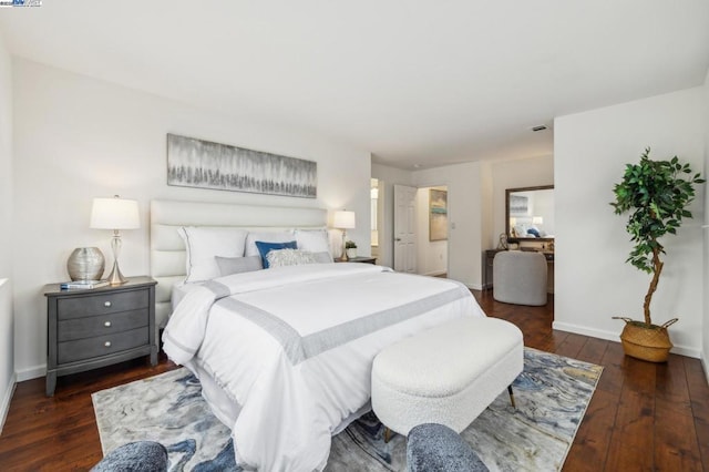 bedroom with dark wood-type flooring