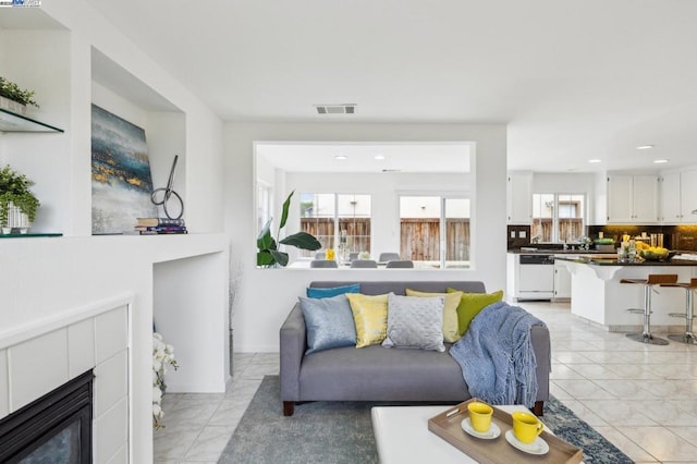 living room featuring a tile fireplace